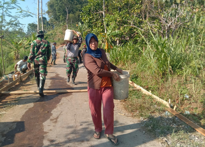 Definisi Wanita Tangguh! Aksi Nyata Ibu Warni Bantu Satgas TMMD 129 Cor Jalan di Desa Cukil